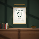 The Perfect Game on a dark green wall under a picture light